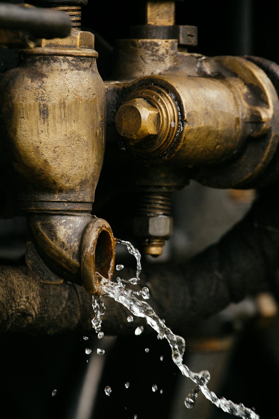 Water spilling from an old brass pipe fitting